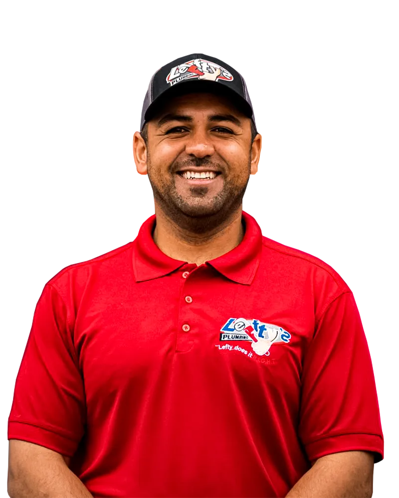 Rafael, owner of Lefty's Plumbing, in a red company polo and cap